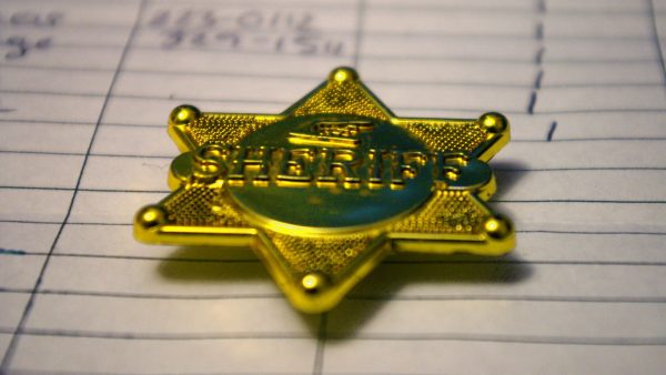 https://archive.wbhm.org/wp-content/uploads/2020/05/Sheriff_Badge-600x338.jpg