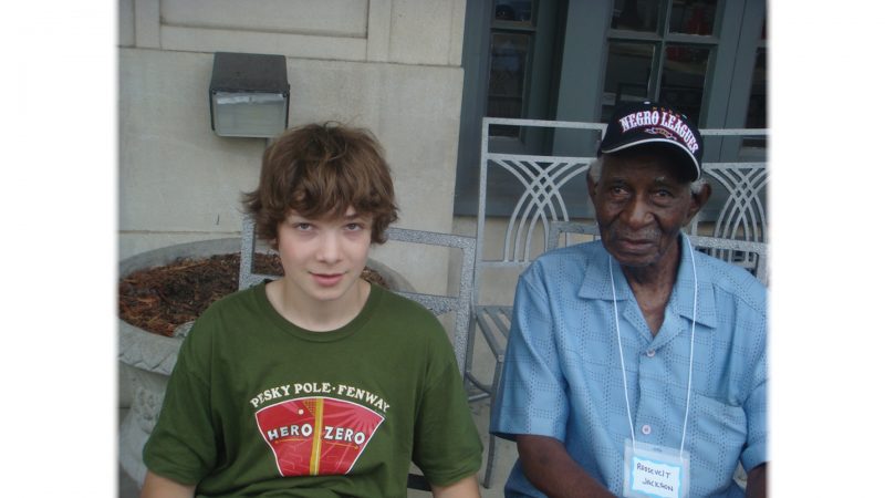 https://archive.wbhm.org/wp-content/uploads/2021/03/Cam_Perron_with_player_Roosevelt_Jackson-800x450.jpg