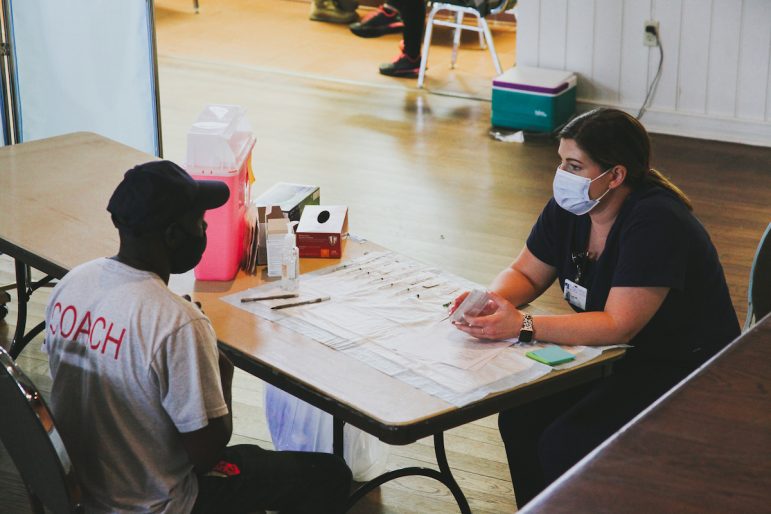 A worker receives a consultation before receiving the vaccine, March 15, 2021.