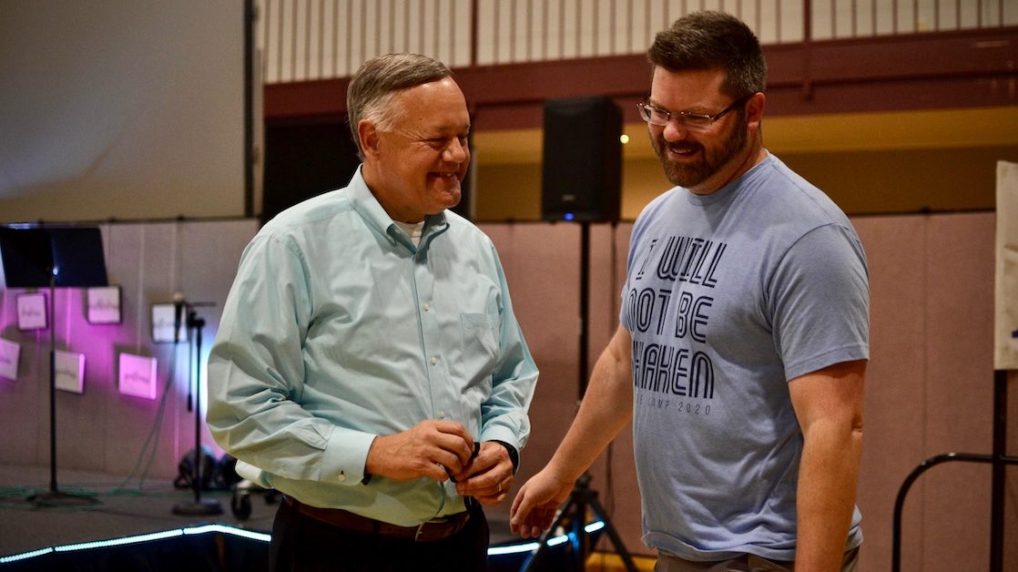 Lloyd Sweat, left, pastor at the Meadowood Baptist Church eases youth minister Casey Powell's anxieties about getting his coronavirus vaccine.