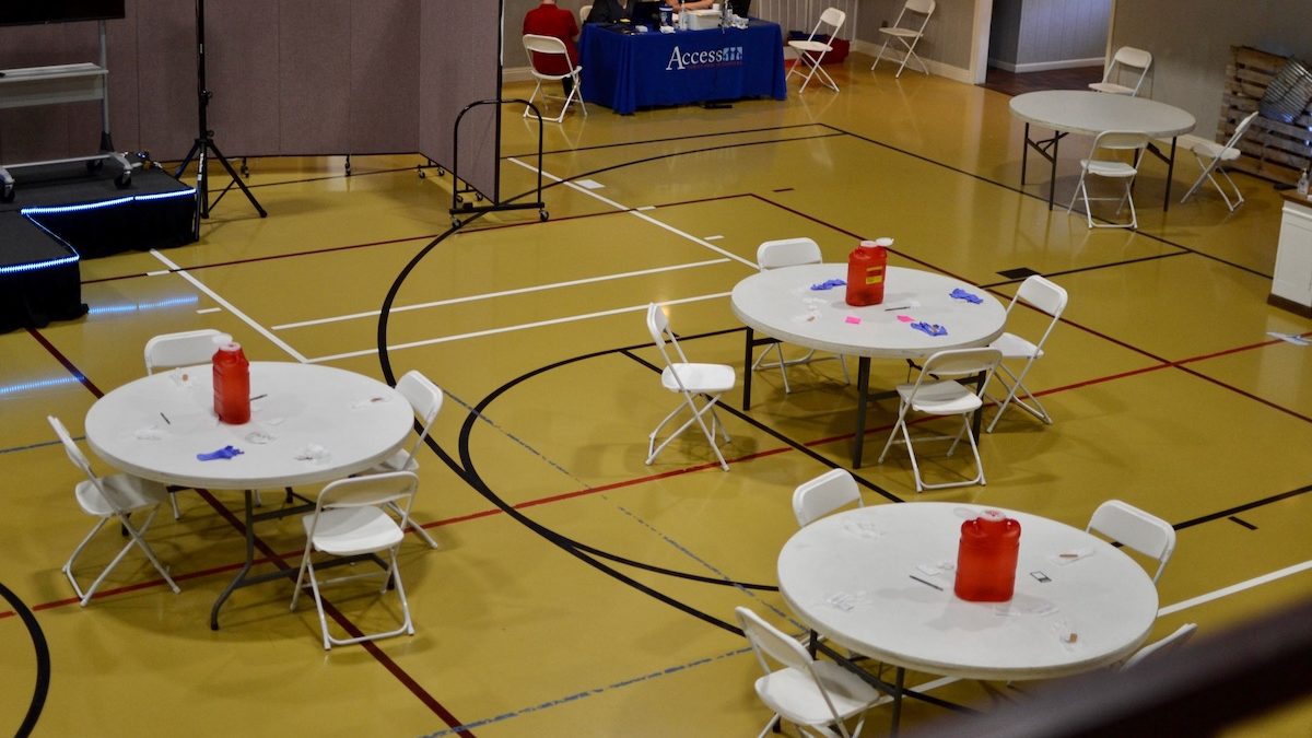 Empty tables and chairs fill the gym of the Meadowood Baptist Church in Amory, Mississippi. The church held a vaccination event with a local community health center, and 30 people trickled through the event to get their vaccines.