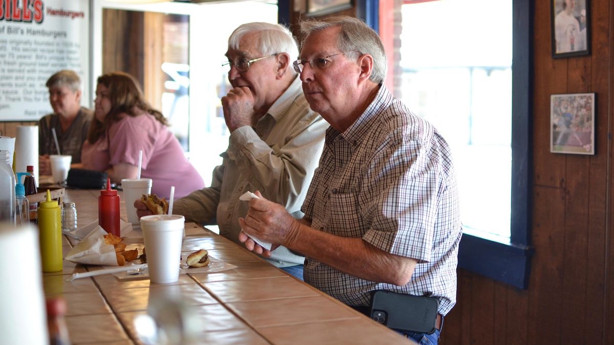 John Holliman, far right, stopped at Bill's Burgers in downtown Amory, Miss., for lunch said he got his first Moderna shot, but said it "nearly killed him." He’s decided not to get his second shot.