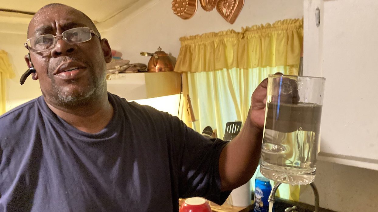 George Reynolds filled a glass of water at his house in Murphy, Miss.