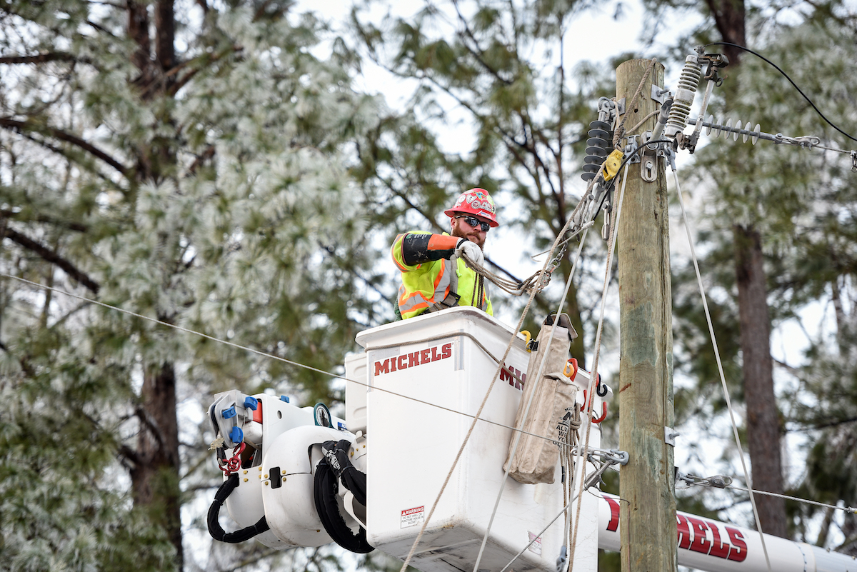 An Entergy crewmember works to restore power to a neighborhood in Vicksburg, Mississippi after Winter Storm Uri swept through the region, Feb. 19, 2021.