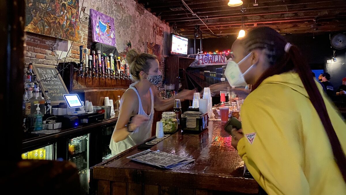 Bartenders and patrons at Howlin’ Wolf in New Orleans are required to wear masks in July 2021.
