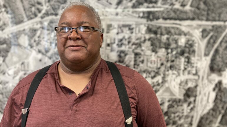 York Mayor Willie Lake stands in front of an aerial photograph of York.