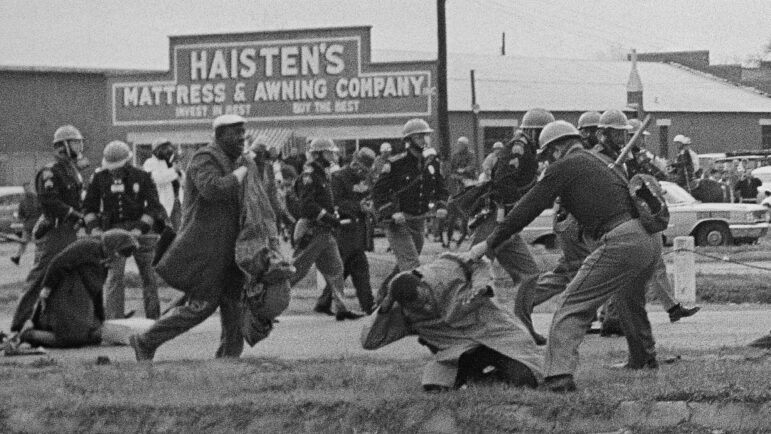 FILE - Alabama state troopers attack voting rights demonstrators in Selma, Ala., in this file photo from March 7, 1965. Despite being known worldwide as a beacon of voting rights, the city and surrounding Dallas County had one of the worst voter turnouts in Alabama for the 2020 presidential election, and some are trying to increase voter participation. (AP Photo/File)