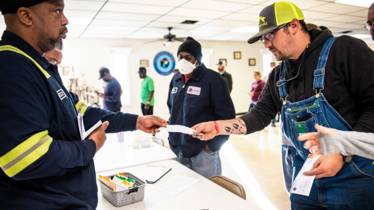 A striking coal miner picks up his strike checks from the United Mine Workers of America at a local union hall in Brookwood, Alabama.
