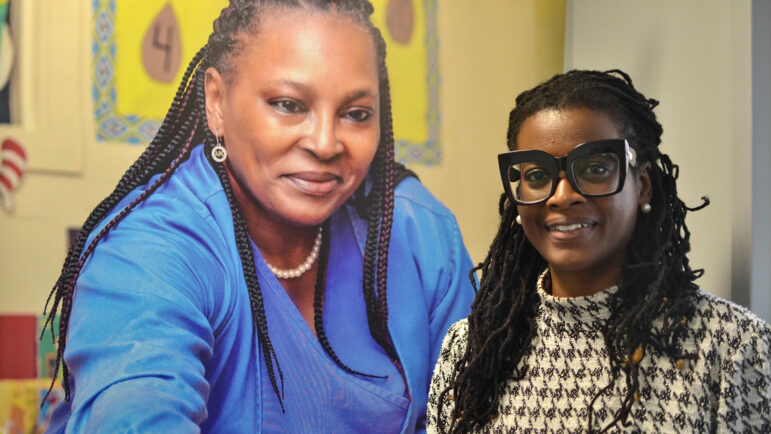 Cassandra Welchlin poses in front of a mural for a photo in Jackson, Mississippi.