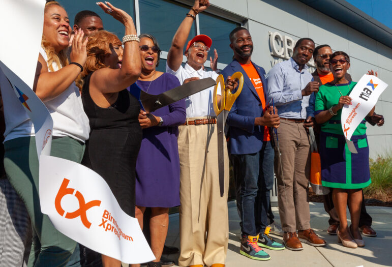 City leaders celebrate after a ribbon-cutting ceremony for a new Xpress Rapid Bus Line on Thursday.