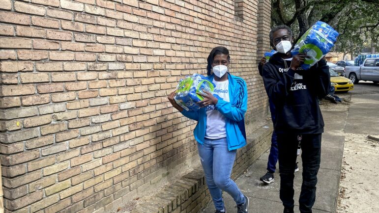 In this file photo, volunteers with Operation Good, a community organization, deliver cases of water to South Jackson residents, Feb. 2021.