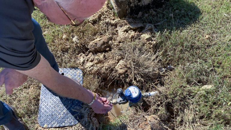 Byram Mayor Richard White returns to a resident’s home to check on her water meter, Oct. 7, 2022.