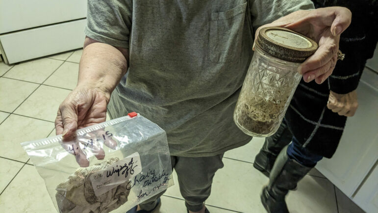 Barbara Weckesser holds up her own samples of neighborhood dust that she’s collected in Pascagoula, Mississippi, December 17, 2022.