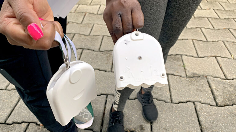 LSU School of Public Health graduate student researchers Jacquelynn Mornay and Beatrice Duah hold air monitors at Hunter’s Field Playground in New Orleans on July 18, 2023.