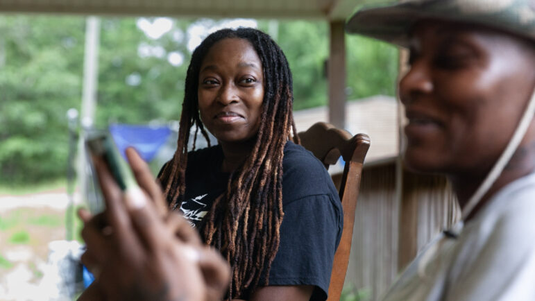 Tyronda Curry-Hurst sits on her porch with her wife, Dolabriel Curry-Hurst, on July 13, 2023, in Duncanville, Alabama.