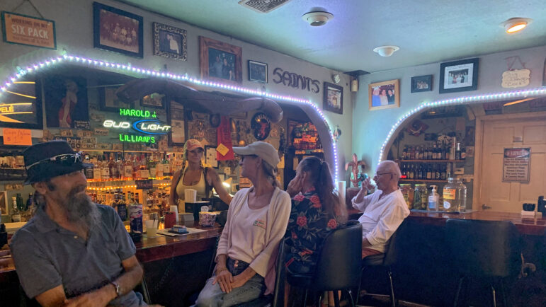 Patrons sit inside Harold and Lillian’s, a bar in Clermont Harbor, Mississippi, on Tuesday, August 29, 2023.