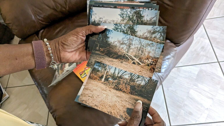Florence Jordan shows photos of damage to her home by Hurricane Katrina on Sunday, August 27, 2023.