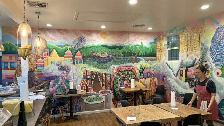 Merritt Coscia rearranges tables in the Plume Algiers dining room in New Orleans on November 18, 2023.