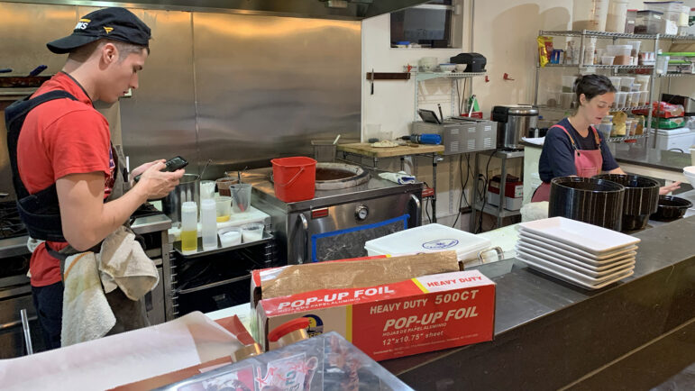 Tyler Stuart and Merritt Coscia finish some last-minute prep work ahead of opening Plume Algiers in New Orleans on November 18, 2023.