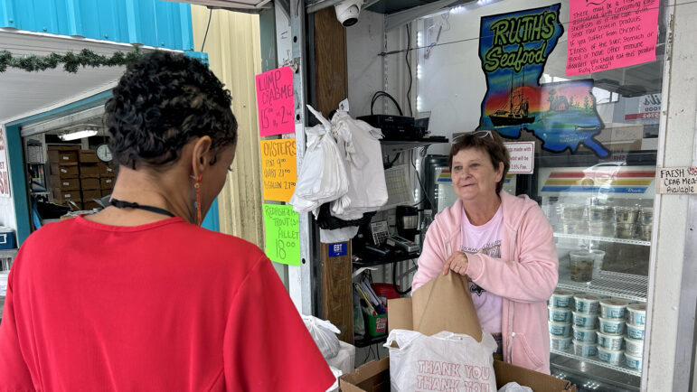 Bunny Young buys fresh shrimp from a vendor at the Westwego Shrimp Lot in Westwego, Louisiana, on Dec. 8, 2023.