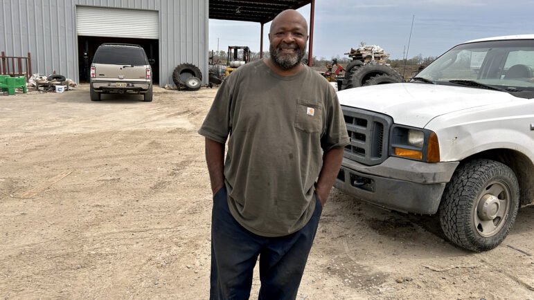 Charles Jones stands outside of the auto shop he works at in Rolling Fork, Mississippi, on Thursday, March 21, 2024.