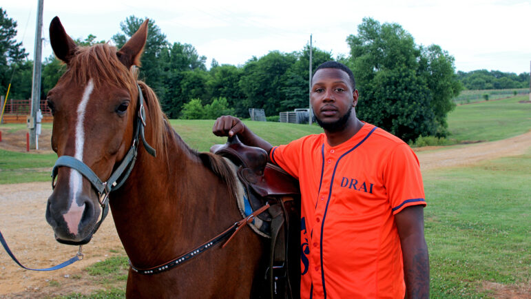 Dre Gorman stands beside his horse Cali before the Pontotoc Juneteenth Horse Show on June 19, 2024.