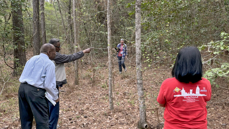 Franklin Tate and his brother Kenneth, search through the woods of Little River, Alabama, for markers of their family’s property.