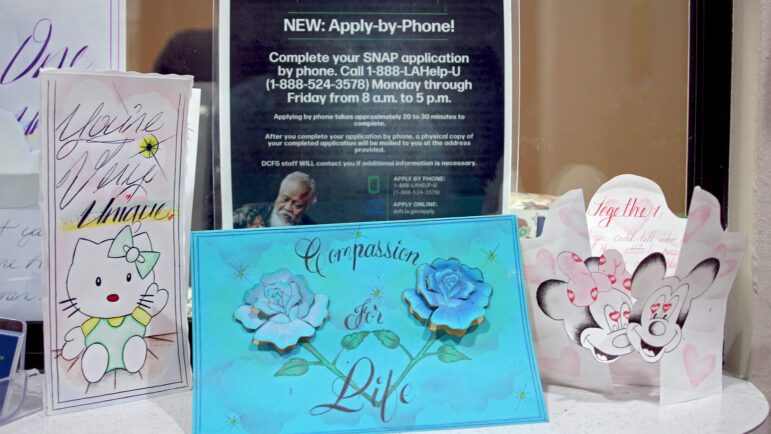 Cards and information about applying for food assistance are in the front window of Compassion for Lives' office in Shreveport, Louisiana.