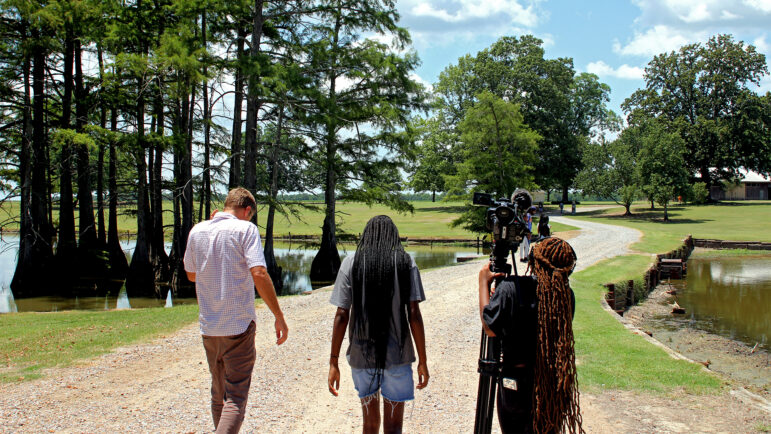 Instructor Brian Graves walks with two student filmmakers in Drew, Mississippi, on June 21, 2024.