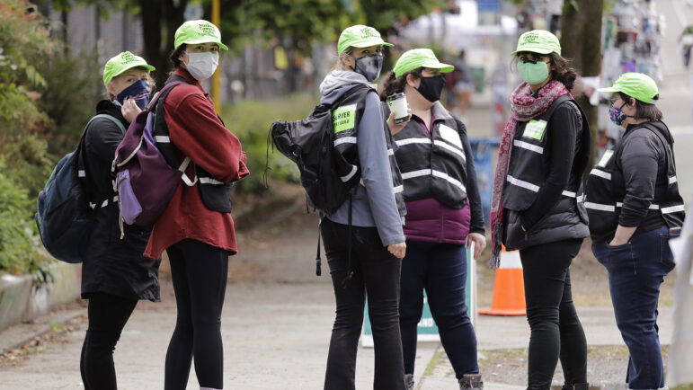 In this file photo, Legal observers from the National Lawyers Guild look on Sunday, June 28, 2020, in Seattle.
