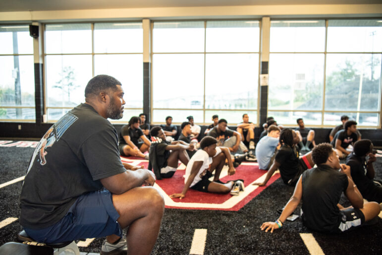 Coach O sits with players on the Shades Valley High School football team during a morning devotional on Nov. 19, 2024.