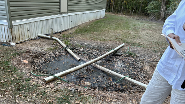 Sherry Bradley stands next to a straight pipe on Monday, October 28, 2024, in White Hall, Alabama.