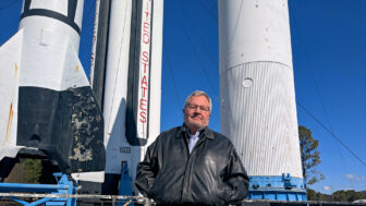 Mike Ward, senior vice president of government and public affairs at the Huntsville/Madison County Chamber, stands before historic rockets at Redstone Arsenal in Huntsville, Alabama, on Jan. 24, 2025.