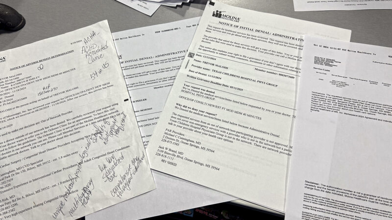 A stack of denial letters and correspondence from Molina Healthcare and Ochsner Health lie on a table in the Malosh family store in Ocean Springs, Mississippi, on Dec. 20, 2024.