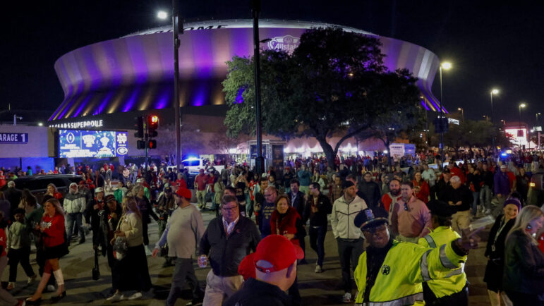 Fans leave the Caesars Superdome with a large presence of security after the Sugar Bowl NCAA College Football Playoff game, Thursday, Jan. 2, 2025, in New Orleans.