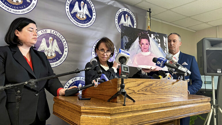 Attorney General Liz Murrill holds a picture of Mary "Molly" Elliott following the execution of Jessie Hoffman on March 18, 2025, while Department of Public Safety & Corrections Secretary Gary Westcott (right) looks on.