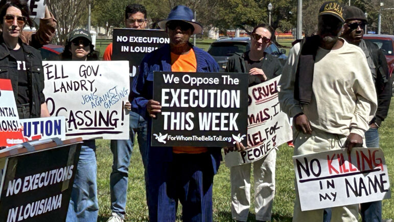 Advocates hold signs at a rally across the street from the Louisiana Governor’s Mansion in Baton Rouge on March 16, 2025, to oppose the execution of Jessie Hoffman Jr.