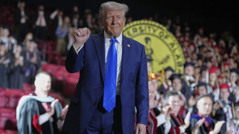 President Donald Trump gestures after giving a commencement address at the University of Alabama,.