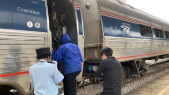 Passengers climb aboard an Amtrak train in Birmingham, Alabama, on April 8, 2022.