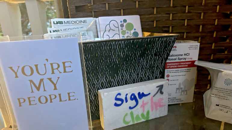 Harm reduction supplies, including treatment information and naloxone, are displayed on a table on Suzanne Smith’s porch in Birmingham, Alabama, on April 6, 2025.