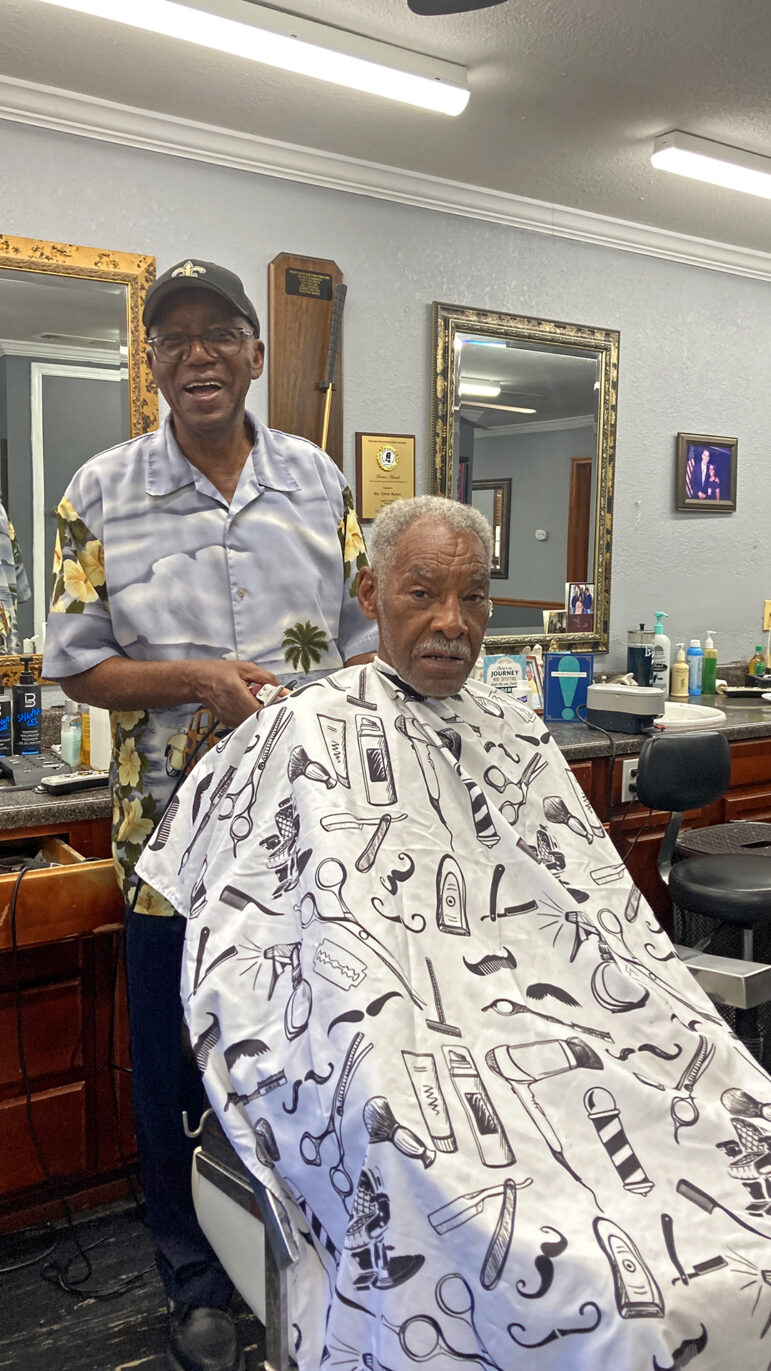 Tyrone Burton cuts hair at Tyrone’s Barber and Beauty Salon in East Biloxi, Mississippi, on Aug. 14, 2025.