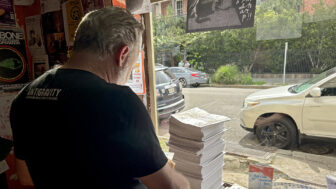 Antigravity editor-in-chief Dan Fox delivers and arranges the July issue of the magazine at a coffee shop in New Orleans on Tuesday, July 1, 2025.