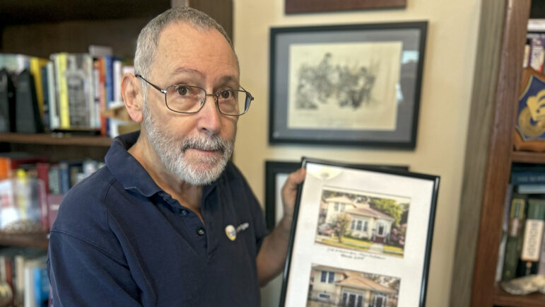 Former New Orleans Times-Picayune reporter and editor Mark Schleifstein holds a photo of his flooded home after Hurricane Katrina in New Orleans on Thursday, June 26, 2025.