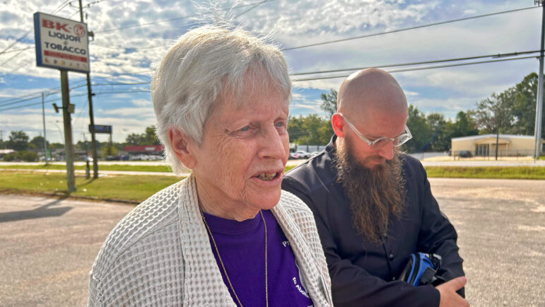 Esther Brown (left) and Rev. Jeff Hood (right) talk to media near a billboard for the Execution Intervention Project's "Save Anthony Boyd" campaign on Friday, Sept. 26, 2025.