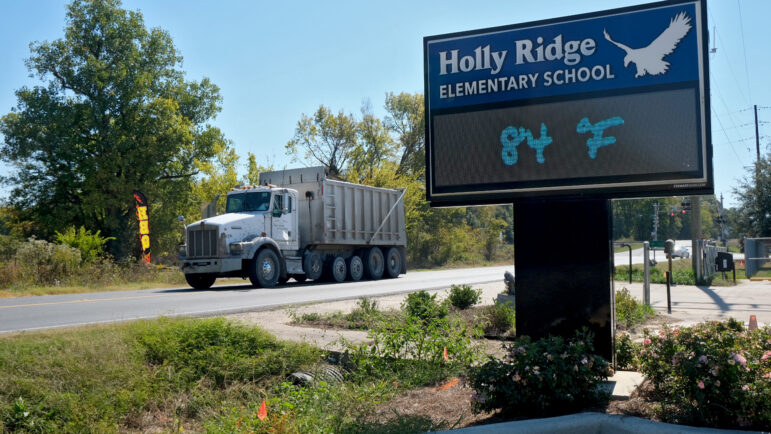 A dump truck drives past Holly Ridge Elementary School in Holly Ridge, Louisiana, on Friday, October 17, 2025.