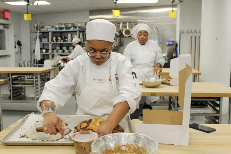 Cho boxes up her coffee and orange king cake to take home.