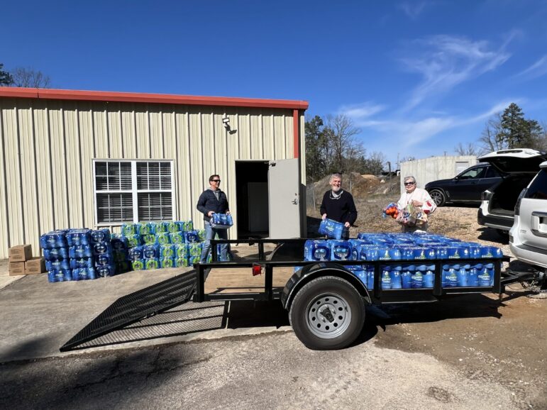 Pine Lake Church volunteers with water donations in Tula, a community in Lafayette County, on Feb. 4.