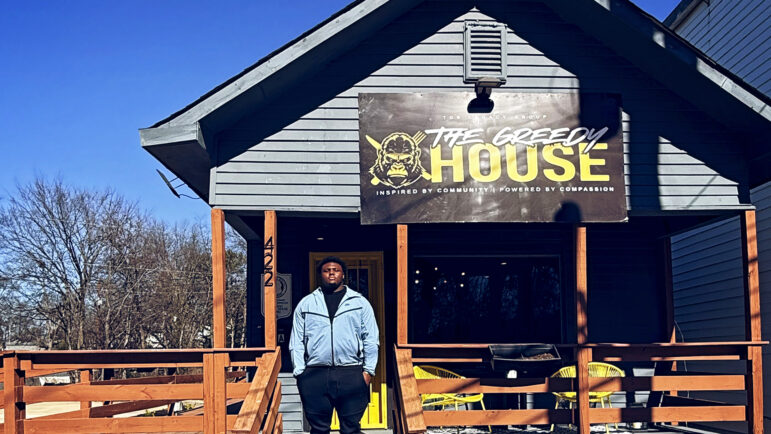 Jourdin Crawford stands in front of the Greedy House in Birmingham, Alabama.